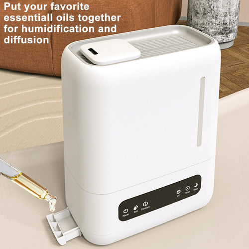 Hand pouring water into the wide top-fill opening of the 4L humidifying diffuser, no disassembly needed